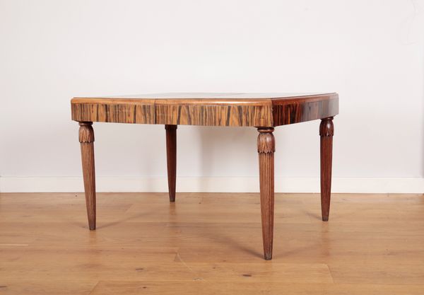 AN ART DECO COROMANDEL AND MAHOGANY EXTENDING DINING TABLE