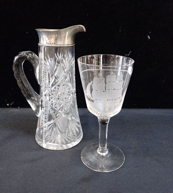 A SILVER MOUNTED CUT GLASS JUG