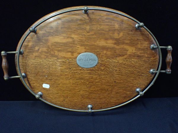 AN EDWARDIAN OAK OVAL TRAY, WITH NICKEL-PLATED FITTINGS