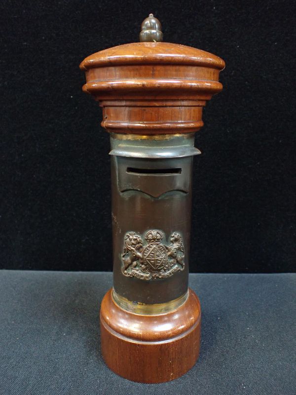 A BRASS AND WOOD PILLAR BOX MONEY BANK