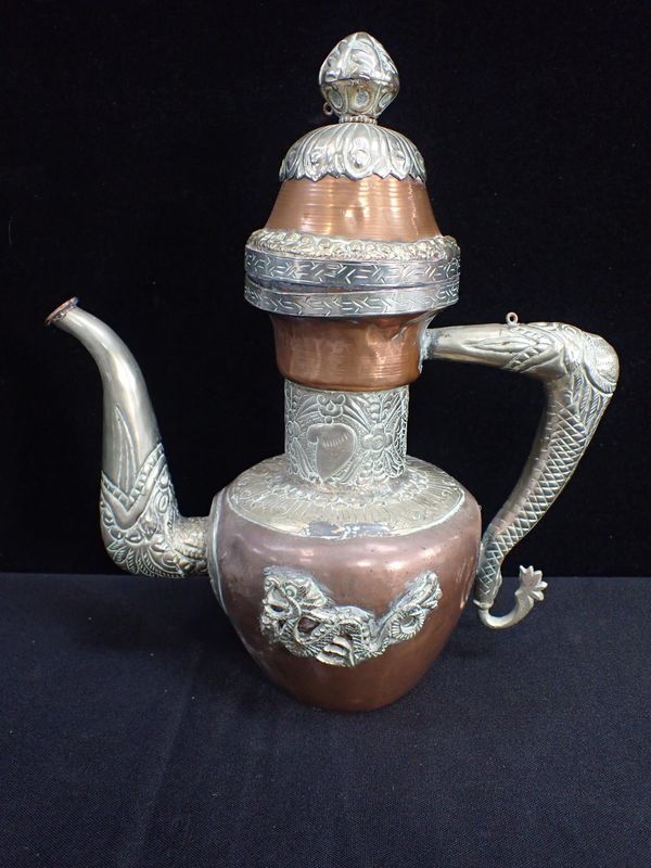 A TIBETAN COPPER, BRASS AND WHITE METAL TEAPOT