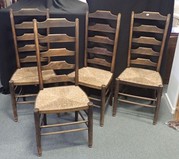 A SET OF FOUR ARTS AND CRAFTS RUSH SEATED LADDER BACK CHAIRS