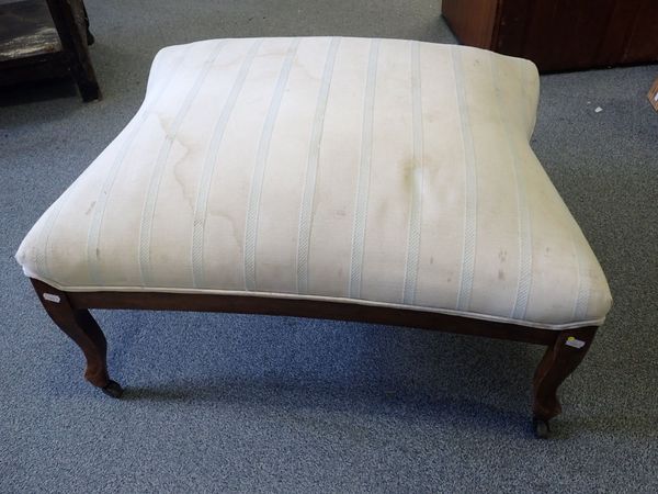 AN UPHOLSTERED FOOTSTOOL WITH FRENCH STYLE LEGS