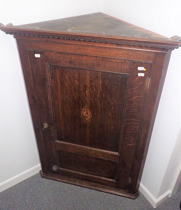 A GEORGE III OAK HANGING CORNER CUPBOARD