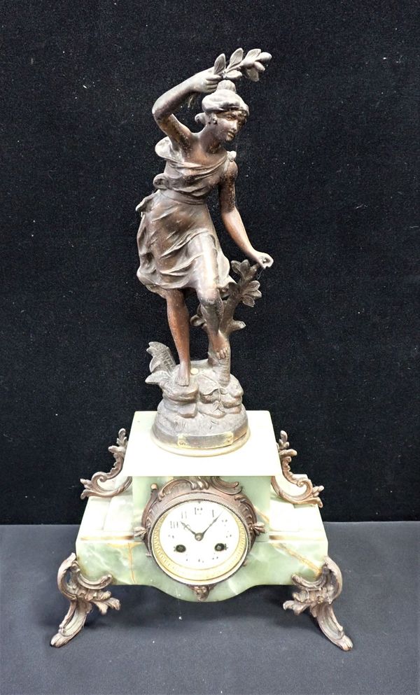 AN ONYX AND SPELTER FIGURAL CLOCK