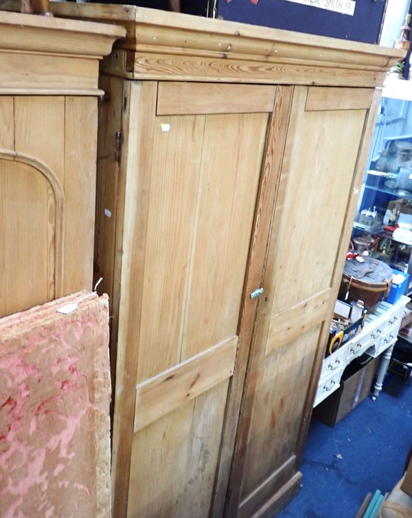 A LARGE VICTORIAN STRIPPED PINE LINEN CUPBOARD