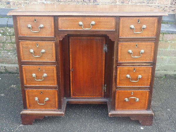 A GEORGE III MAHOGANY KNEEHOLE DESK