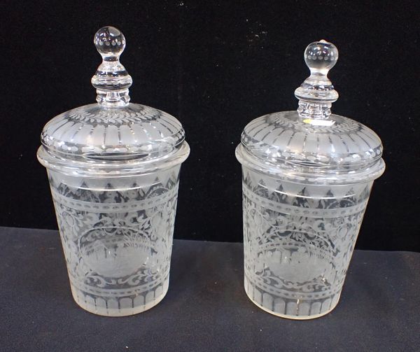 A PAIR OF NORTHERN EUROPEAN ENGRAVED GLASS LIDDED JARS