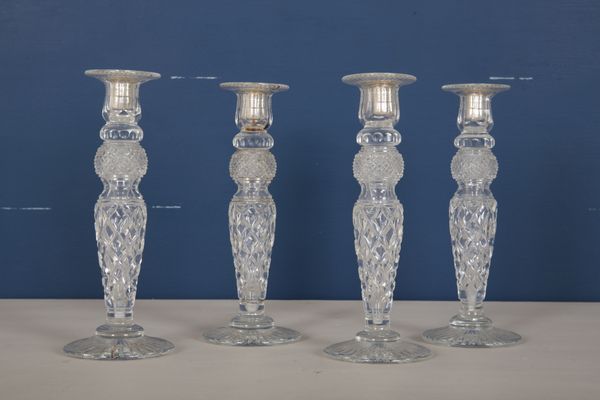 A SET OF FOUR ENGLISH CUT GLASS CANDLESTICKS