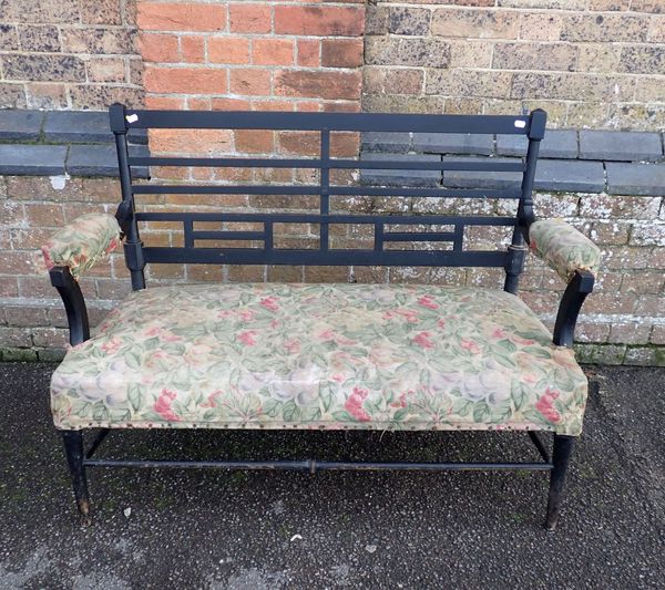 A VICTORIAN EBONISED SETTEE, AFTER THE STYLE OF E.W. GODWIN