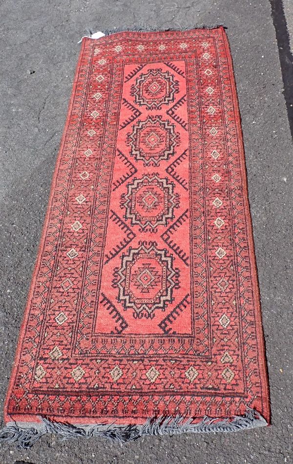 A RED GROUND AFGHAN RUG