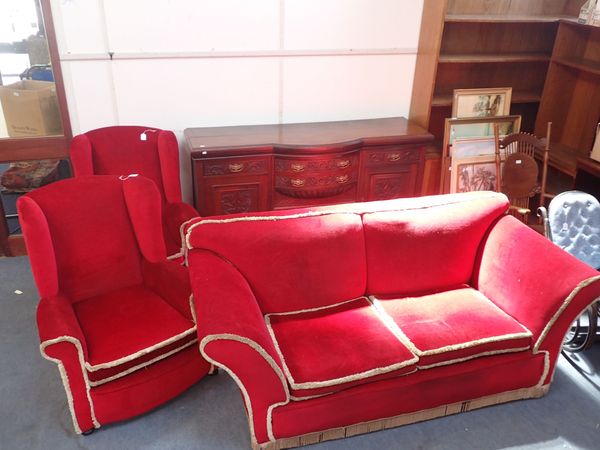 A 1920S SOFA, WITH LOW BACK AND SPLAYED ARMS, ON BUN FEET