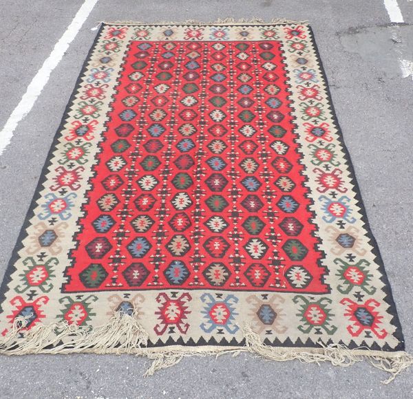 A KILIM WITH RED GROUND