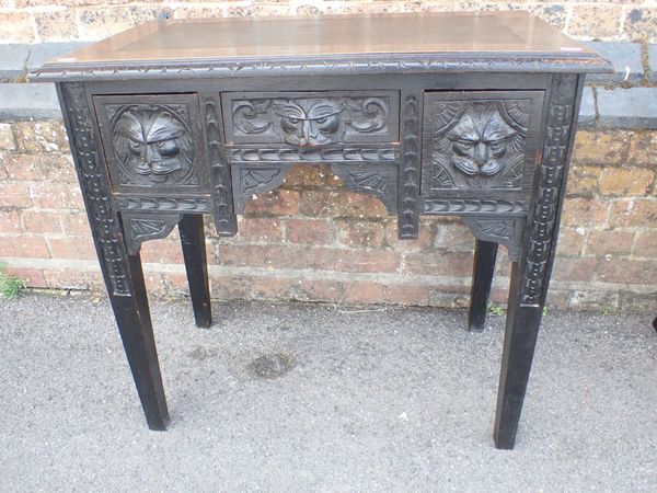 A VICTORIAN CARVED OAK DESK, OF SMALL PROPORTIONS