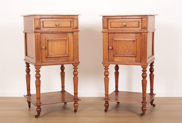 A PAIR OF FRENCH OAK BEDSIDE TABLES