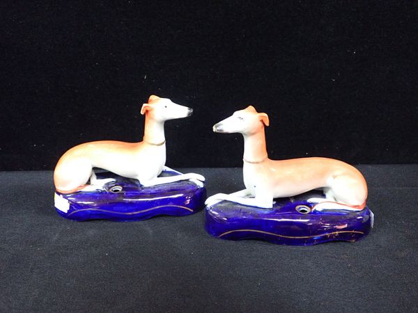 A PAIR OF STAFFORDSHIRE GREYHOUND INKWELLS