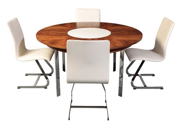 RICHARD YOUNG FOR MERROW ASSOCIATES: A ROSEWOOD DINING TABLE WITH CENTRAL LAZY SUSAN AND SET OF FOUR CHROME AND LEATHER CHAIRS