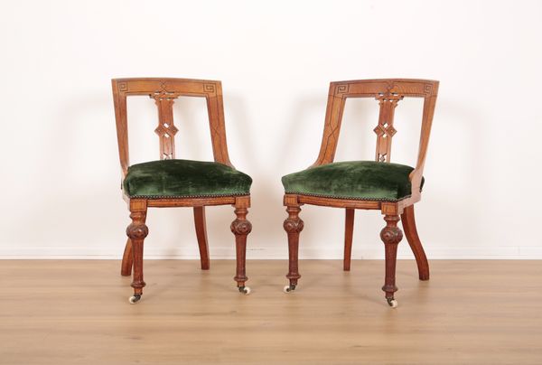 A PAIR OF VICTORIAN AESTHETIC OAK LIBRARY CHAIRS