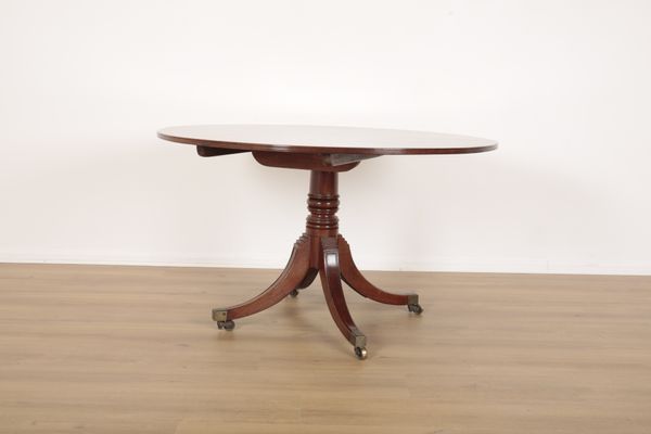 A REGENCY STYLE MAHOGANY DINING TABLE