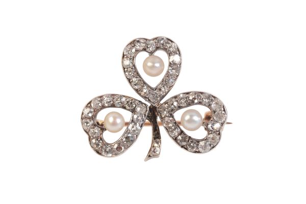 AN EDWARDIAN DIAMOND AND SEED PEARL CLOVER FORM BROOCH