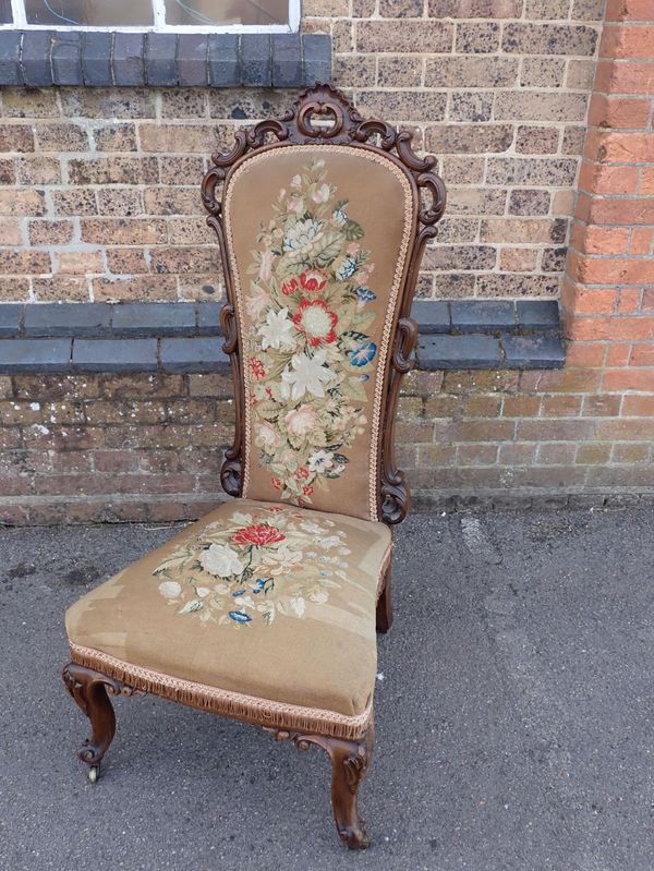 A VICTORIAN ROSEWOOD FRAMED CHAIR WITH WOOL WORK UPHOLSTERY