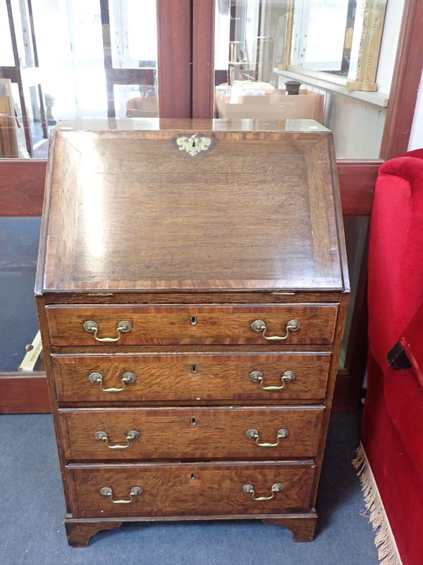 AN OAK AND MAHOGANY CROSSBANDED BUREAU OF SMALL PROPORTIONS