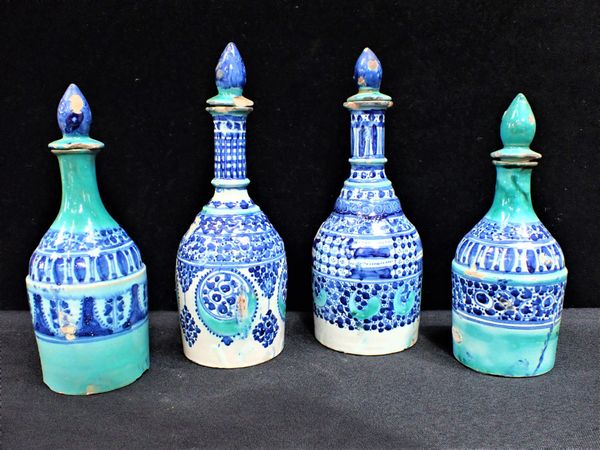 FOUR FAIENCE OIL JARS WITH STOPPERS