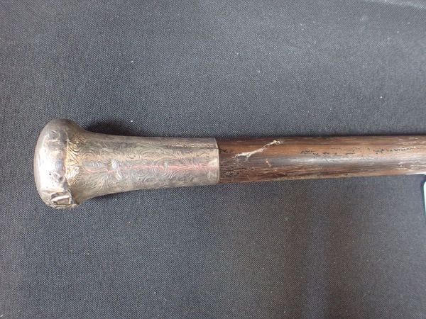 A SILVER-TOPPED CANE