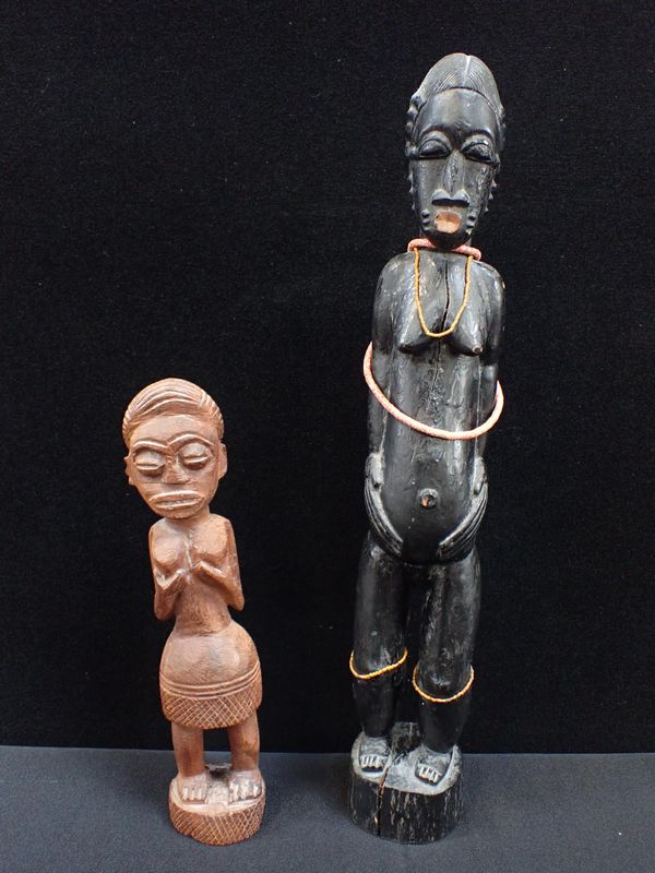 AN AFRICAN TRIBAL FIGURE WITH WORN SURFACE AND BEAD STRINGS