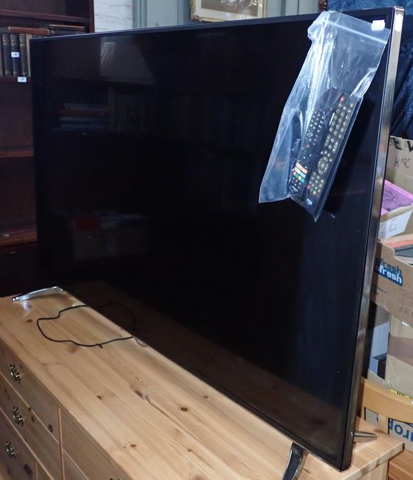 A LARGE HITACHI FLAT SCREEN TELEVISION