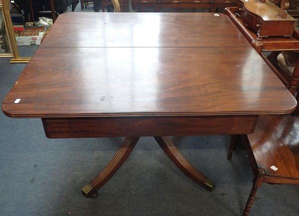 A REGENCY MAHOGANY DRAW-LEAF DINING TABLE