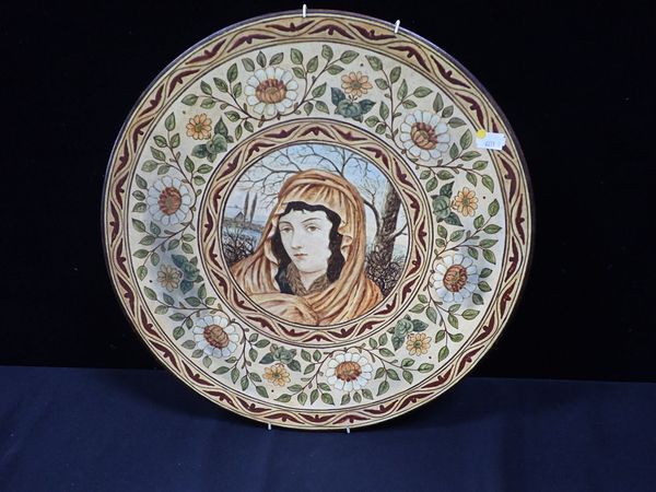 VICTORIAN POTTERY PLAQUE, PAINTED WITH A FEMALE HEAD IN A WINTRY LANDSCAPE