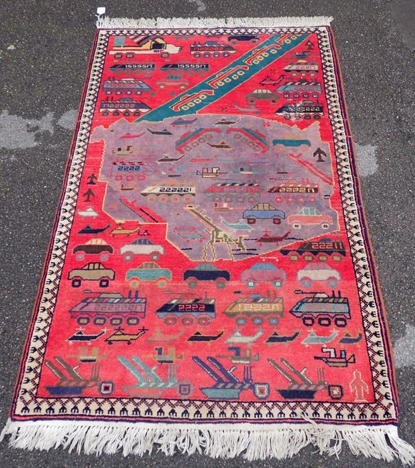 AN AFGHAN 'WAR RUG' WORKED ALL OVER WITH WEAPONS, VEHICLES AND OTHER TOPICAL MOTIFS