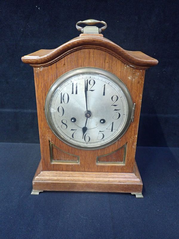 AN EDWARDIAN OAK-CASED MANTEL CLOCK