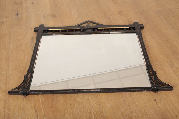 A VICTORIAN EBONISED AND PARCEL GILT MIRROR OF AESTHETIC DESIGN