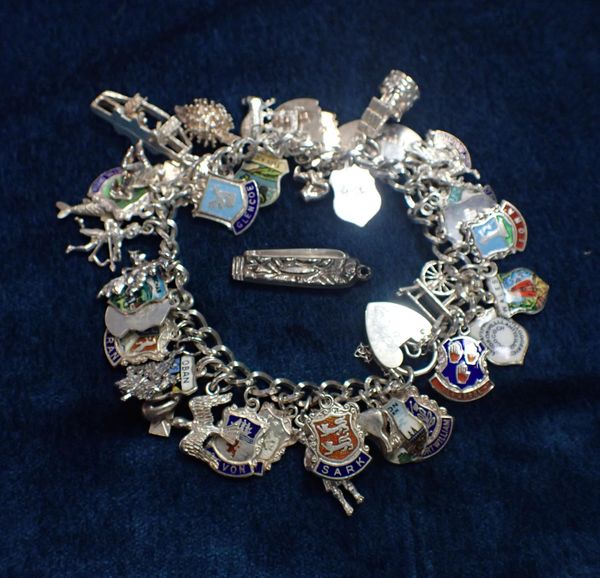 A QUEEN ELIZABETH II  SILVER BRACELET WITH CHARMS