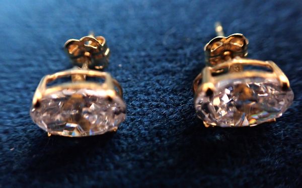 A PAIR OF OVAL CUT CUBIC ZIRCONIA STUD EARRINGS