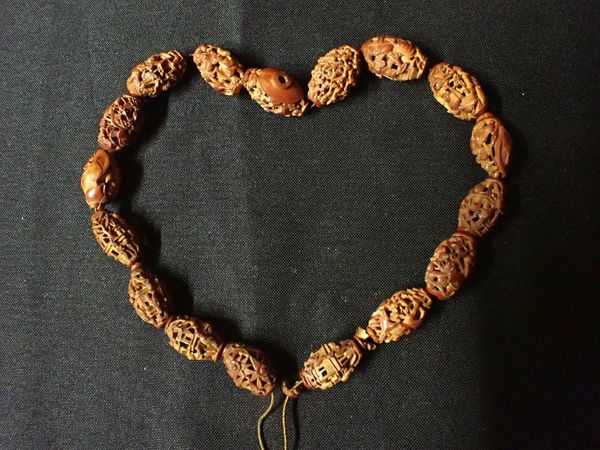 A CARVED NUT NECKLACE