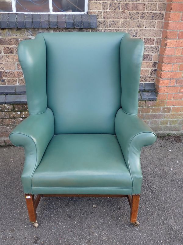 A GEORGE III STYLE WING-BACK ARMCHAIR