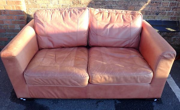 A MODERN LEATHER TWO-SEATER SOFA