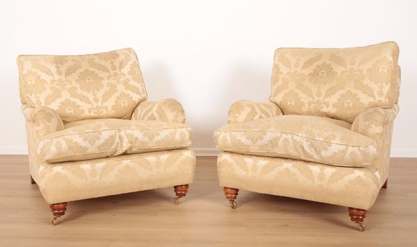 A PAIR OF HOWARD TYPE ARMCHAIRS