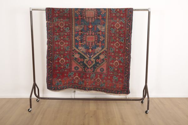 AN ANTIQUE HAMADAN RUG