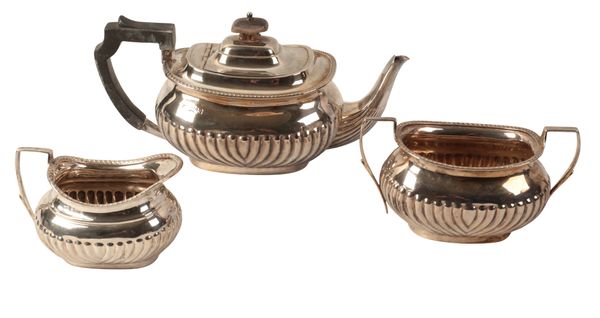 A LATE VICTORIAN SILVER THREE PIECE TEA SERVICE