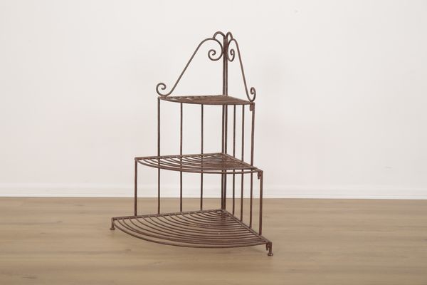 A WROUGHT IRON THREE TIER JARDINIERE STAND