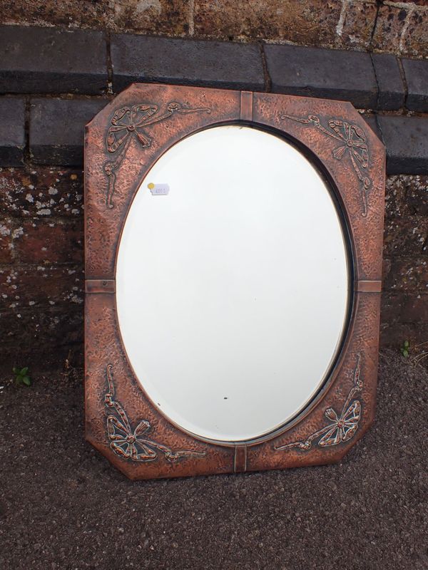 AN EARLY 20TH CENTURY COPPER-FRAMED WALL MIRROR