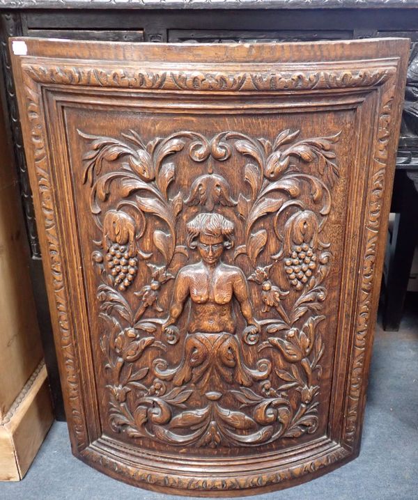 A 19TH CENTURY CARVED OAK BOWFRONT FIRESCREEN