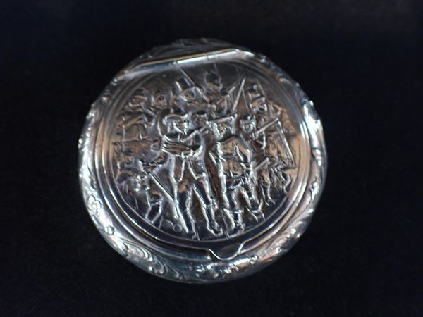 A DUTCH REPOUSSE SILVER CIRCULAR SNUFF BOX