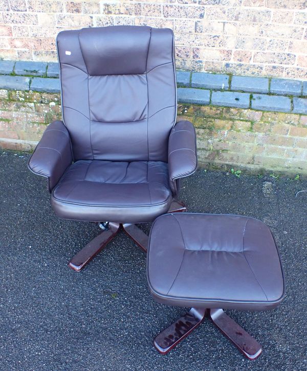 A MODERN SWIVEL ARMCHAIR AND FOOTSTOOL