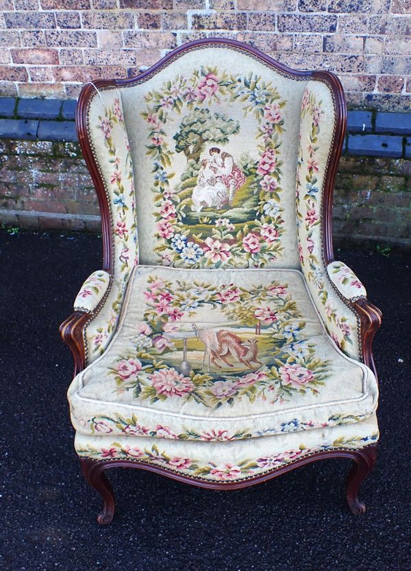 A LOUIS XV STYLE WING ARMCHAIR