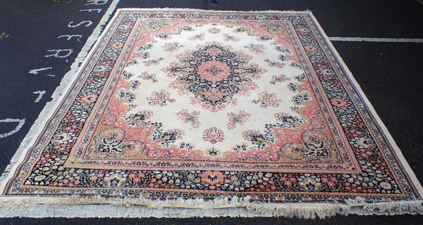 A PALE PERSIAN DESIGN MACHNE-MADE RUG